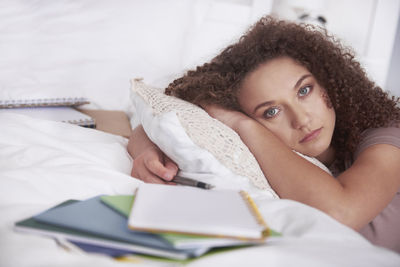 Portrait of woman lying on bed