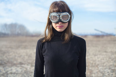 Portrait of girl wearing sunglasses standing on field