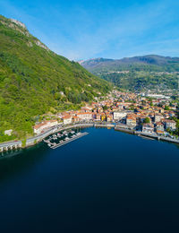 Scenic view of river by buildings against blue sky