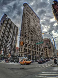 Low angle view of buildings against cloudy sky