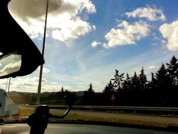 Silhouette man against sky seen through windshield