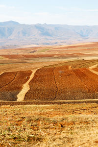 Scenic view of land and mountains against sky