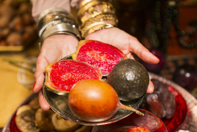 Close-up of hand holding strawberries