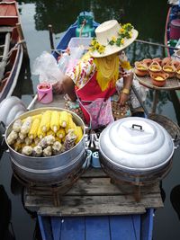 Woman selling corn at damnoen saduak floating market