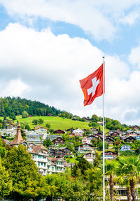 Flag by building against sky in city