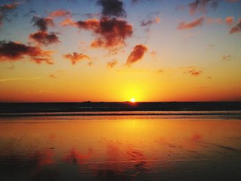 Scenic view of sea against romantic sky at sunset