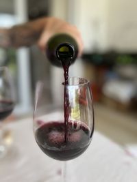 A redwine bottle and glass.