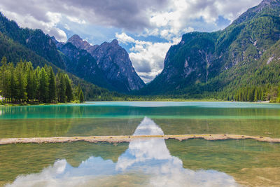 Scenic view of lake and mountains against sky