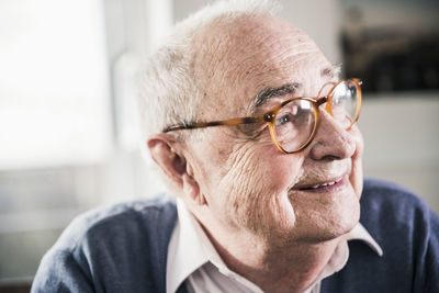 Portrait of smiling senior man looking sideways