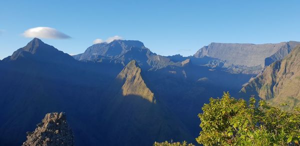 Panoramic view of mountains against clear blue sky