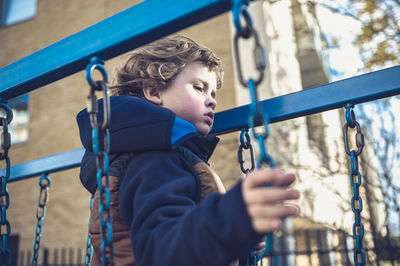 Portrait of boy looking at playground