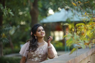 Portrait of young woman looking away outdoors