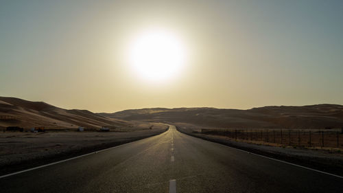 Empty road along countryside landscape