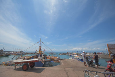 Boats in sea against sky in city