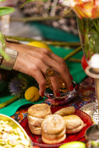 Cropped image of woman with food at table