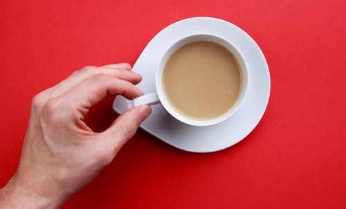 Cropped image of person holding coffee cup