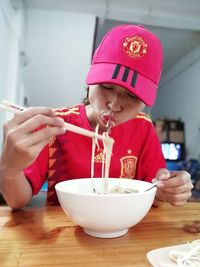 Midsection of man eating food on table