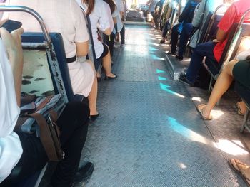 Low section of people walking on railroad track