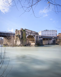 View of bridge over river against cloudy sky