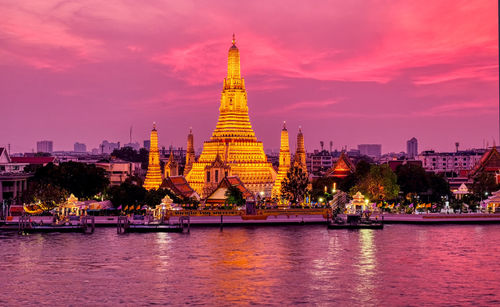 Temple by building against sky during sunset in bangkok 