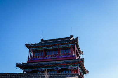 Low angle view of built structure against clear blue sky