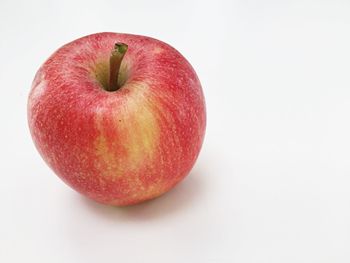 Close-up of red apple on white background