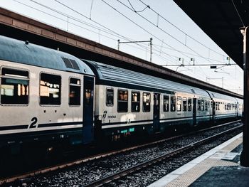 Train at railroad station against sky