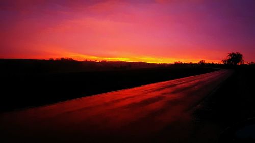 Scenic view of silhouette landscape against sky at sunset