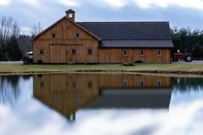 Reflection of building on lake against sky