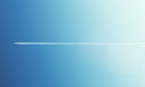 Vapor trail against clear blue sky