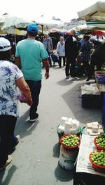 Rear view of people at market