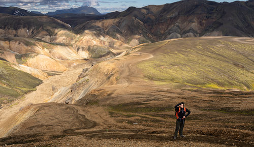 Teenage girl hiking at landmannalaugar, iceland in summer. beautiful and popular hiking place