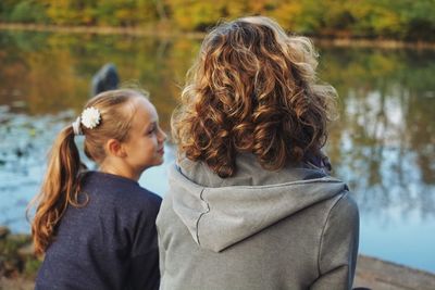 Rear view of mother and daughter outdoors