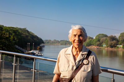 Senior woman at the ronda del sinu walking path along the river bank in montería, colombia.