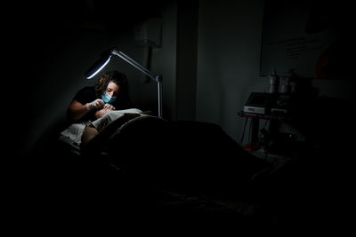 Man sitting on bed at home