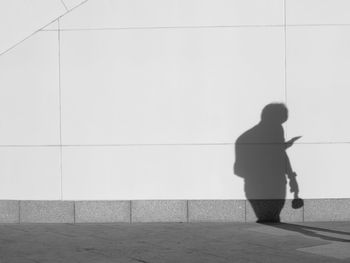 Shadow of man walking on wall