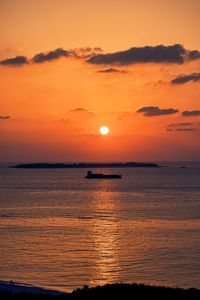 Scenic view of sea against romantic sky at sunset