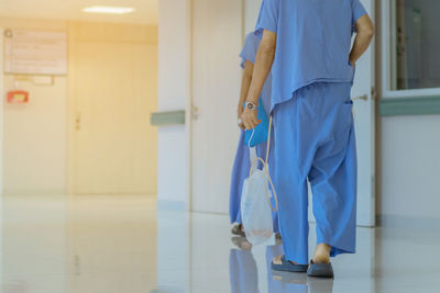 People walking in corridor of building