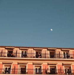 Low angle view of buildings against clear blue sky