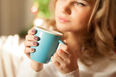 Beautiful woman drinking coffee at home