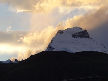 Scenic view of snowcapped mountains against sky during sunset