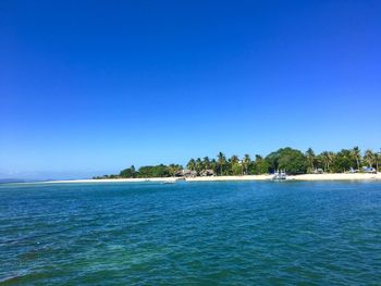 Scenic view of sea against clear blue sky