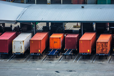 Row of containers against buildings in city