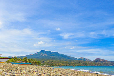 Scenic view of beach against blue sky