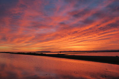 Scenic view of lake against orange sky