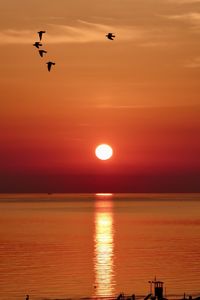 Scenic view of sea against orange sky during sunset