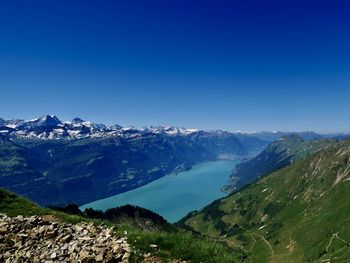 Scenic view of mountains against clear blue sky