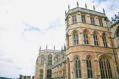 Low angle view of building against cloudy sky