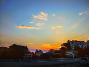 Silhouette cityscape against sky during sunset