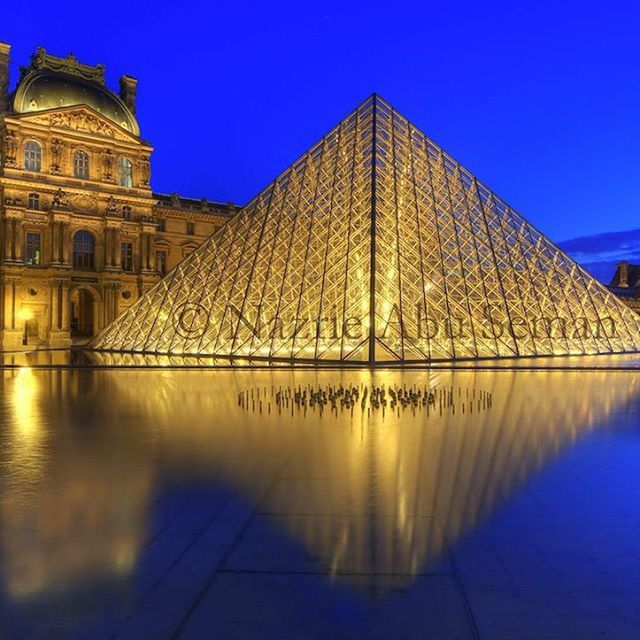 architecture, blue, built structure, clear sky, building exterior, reflection, water, famous place, travel destinations, sunlight, tourism, low angle view, copy space, outdoors, waterfront, city, sky, illuminated, no people, travel